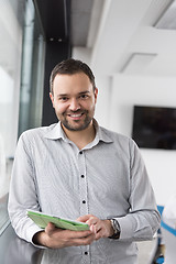 Image showing Businessman Using Tablet In Office Building by window