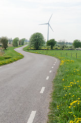 Image showing Wind turbine by a winding country road