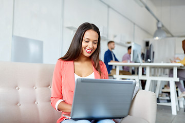 Image showing happy woman with laptop working at office