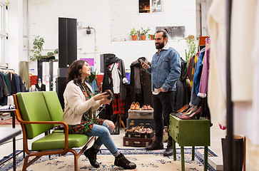 Image showing couple choosing footwear at vintage clothing store