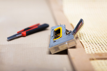 Image showing staple gun and cutter knife with furniture item