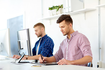 Image showing designer with computer and pen tablet at office