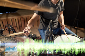 Image showing drummer playing drum kit at sound recording studio