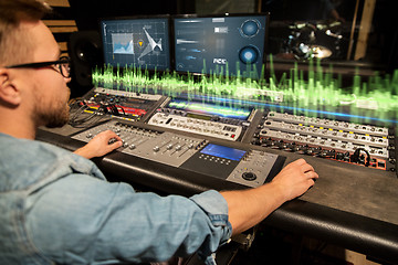 Image showing man at mixing console in music recording studio