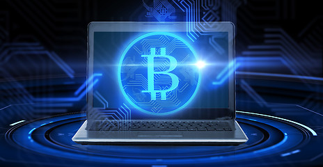 Image showing laptop computer with bitcoin hologram