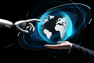 Image showing human and robot hand with virtual earth hologram