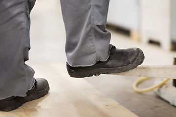 Image showing close up of male worker feet in working shoes