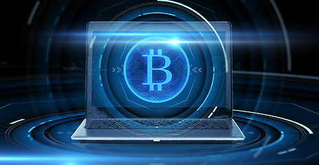 Image showing laptop computer with bitcoin hologram