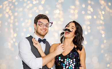 Image showing happy couple with party props having fun