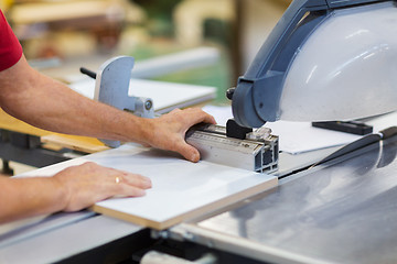 Image showing carpenter with panel saw and fibreboard at factory