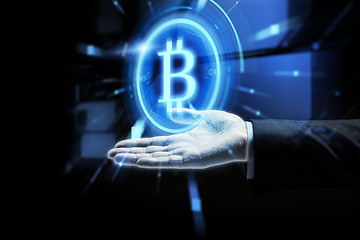 Image showing close up of businessman hand with bitcoin symbol