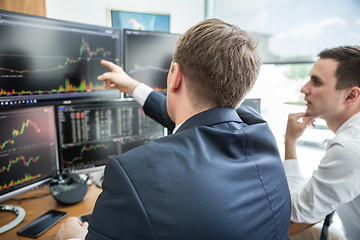 Image showing Stock brokers looking at computer screens, trading online.