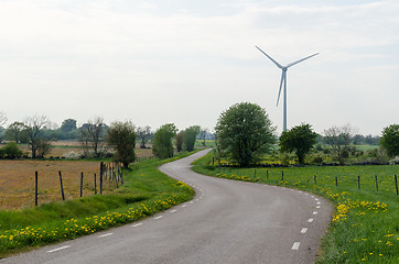 Image showing Winding road by a windmill