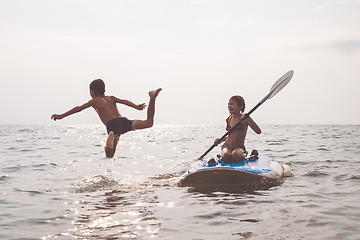 Image showing Happy children playing on the beach at the day time.