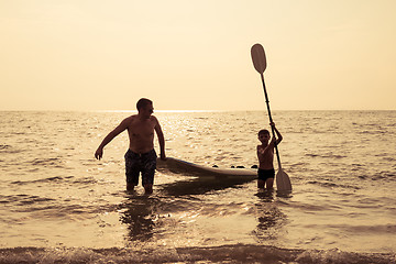 Image showing Father and son  playing on the beach at the day time.