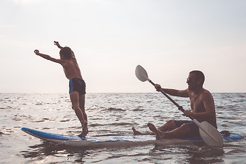 Image showing Father and son  playing on the beach at the day time.