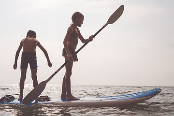 Image showing Happy children playing on the beach at the day time.