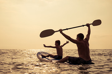 Image showing Father and son  playing on the beach at the day time.