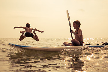 Image showing Happy children playing on the beach at the day time.