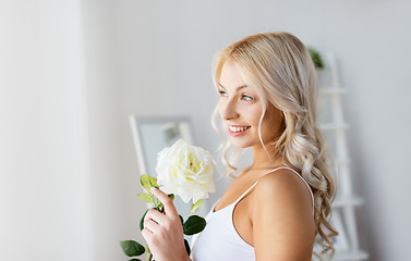 Image showing woman in underwear with rose flower at window