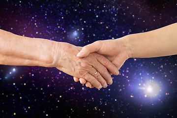 Image showing close up of senior and young woman hands in space