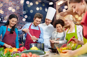 Image showing happy friends and chef cook cooking in kitchen