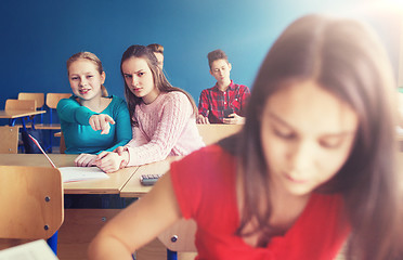 Image showing students gossiping behind classmate back at school