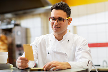 Image showing chef at kebab shop with order or paper note