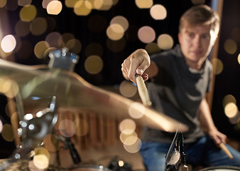 Image showing male musician playing drum kit at concert