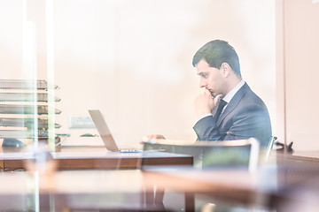 Image showing Businessman in office working on laptop computer.