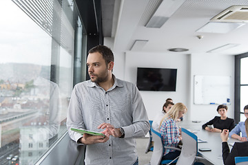 Image showing Businessman Using Tablet In Office Building by window