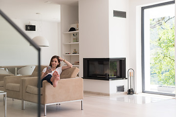 Image showing woman sitting on sofa with mobile phone