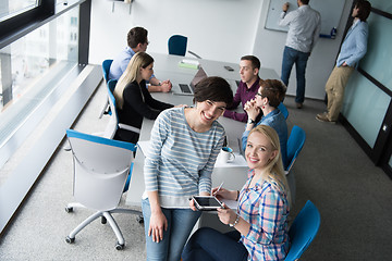 Image showing Pretty Businesswomen Using Tablet In Office Building during conf