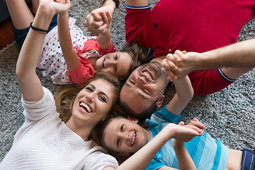 Image showing happy family lying on the floor