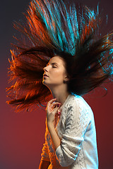 Image showing Trendy hairstyle concept. Young woman with colorful dyed hair on color background