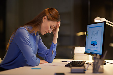 Image showing businesswoman with computer at night office