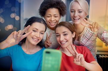 Image showing happy young women taking selfie with smartphone