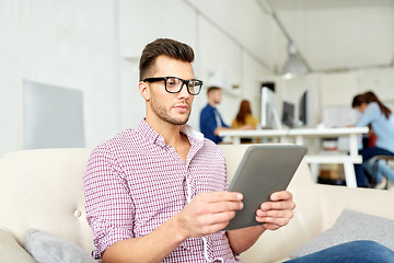 Image showing man in glasses with tablet pc working at office