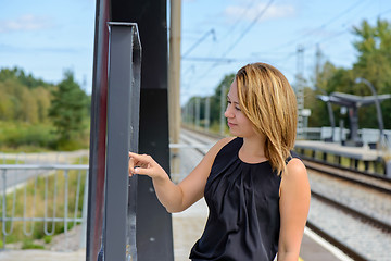 Image showing Woman looking a timetable in a station