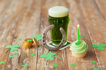 Image showing glass of beer, cupcake, horseshoe and gold coins