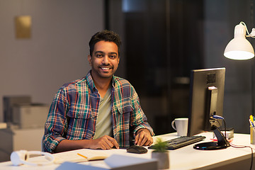 Image showing creative man with tablet pc at night office