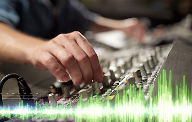 Image showing hands on mixing console in music recording studio