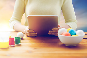 Image showing close up of woman with tablet pc and easter eggs