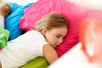 Image showing little girl lying awake in bed at home