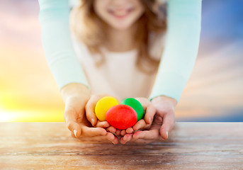 Image showing close up of girl and mother holding easter eggs