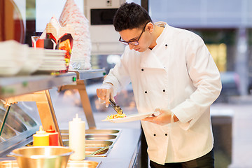 Image showing chef with salad on plate at fast food restaurant