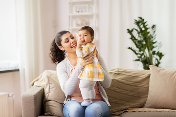 Image showing happy smiling mother with baby daughter at home