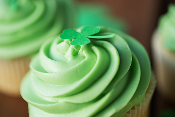 Image showing close up of green cupcake with shamrock decoration