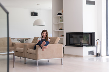 Image showing woman sitting on sofa with tablet computer