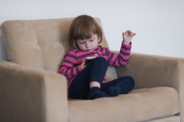 Image showing little girl playing games on smartphone